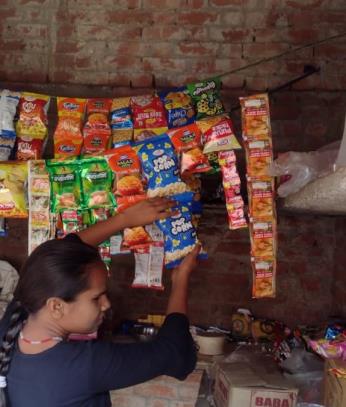 Anita selling wares in her small shop