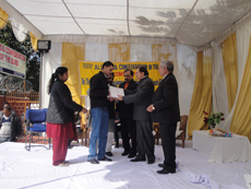 DHEERAJ KUMAR, STUDENT OF JPM SCHOOL FOR THE BLIND DELHI RECEIVING CASH PRIZE OF RS 8000, NATIONAL BRAILLE READING COMPETITION