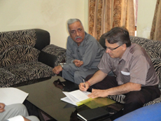 Mr. Ulrich Meinecke, Counselor, Social & Labour Affairs, Embassy of Federal Republic of Germany, signing the Marga Schulze Merit Scholarship list